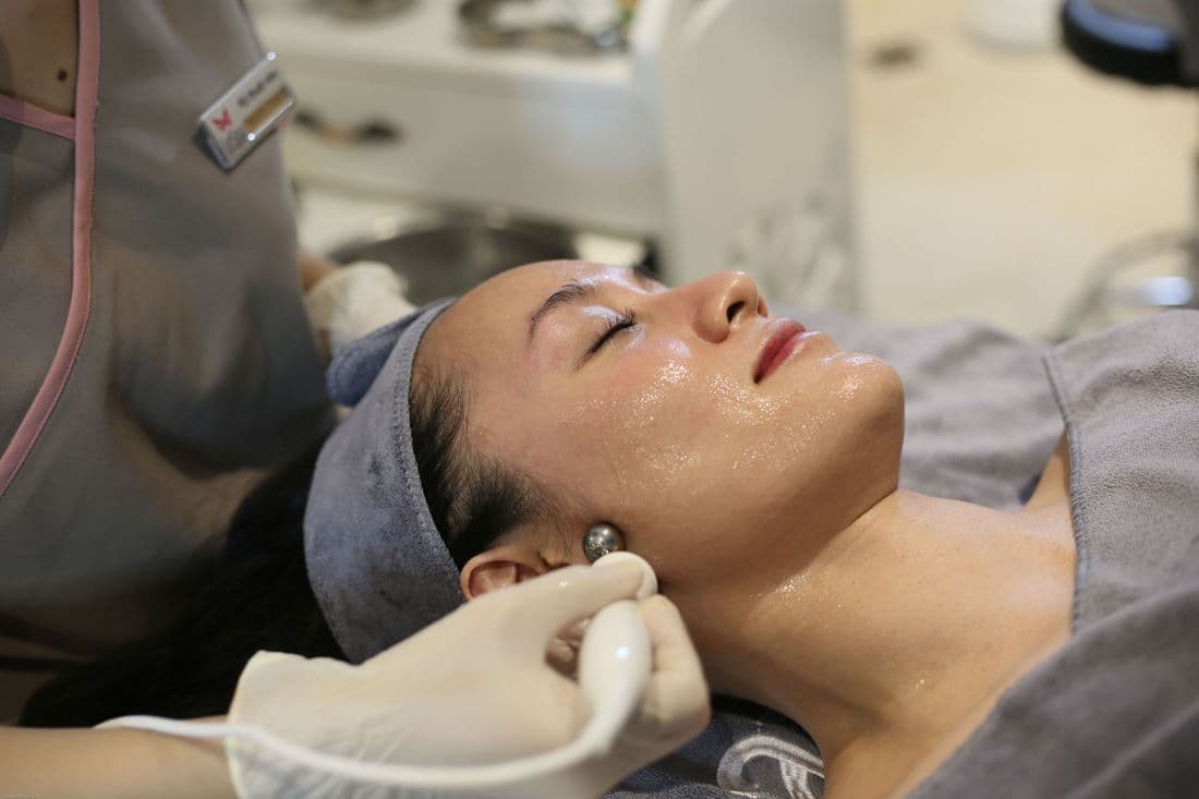 Clienta relajada durante un ritual facial en la clínica